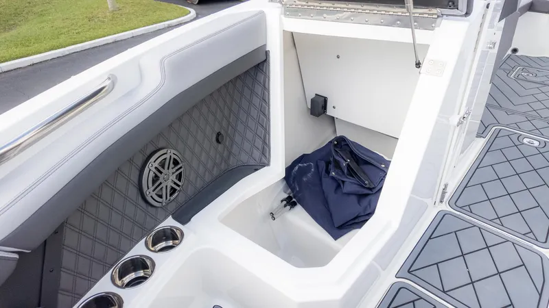 Slide: The Image of 2025 Cobalt R6OB boat interior with storage compartment and speaker. - 30
