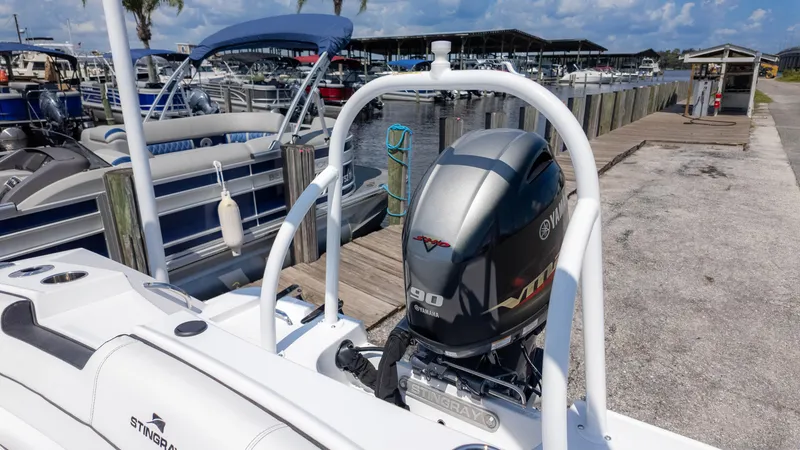 Slide: The Image of 2025 Stingray 172SC boat with Yamaha 90 engine docked at marina. - 10