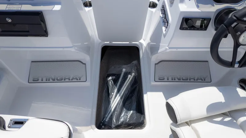 Slide: The Image of 2025 Stingray 172SC boat interior with storage compartment and steering wheel. - 15