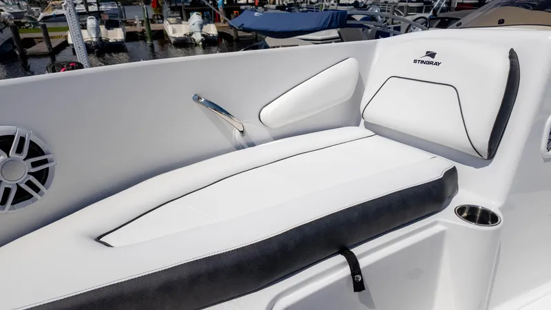 Slide: The Image of 2025 Stingray 172SC boat interior with white cushioned seating and speaker detail. - 19