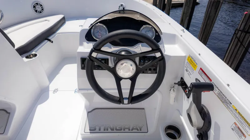 Slide: The Image of 2025 Stingray 172SC boat cockpit with steering wheel and control panel. - 21