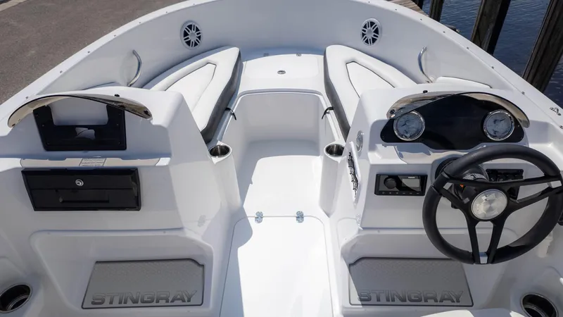 Slide: The Image of 2025 Stingray 172SC boat interior with steering wheel, seating, and dashboard controls. - 8