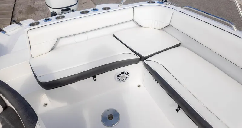 Slide: The Image of 2025 Stingray 192SC boat interior with white cushioned seating and cup holders. - 13
