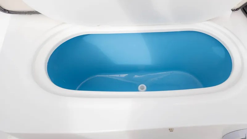 Slide: The Image of Livewell compartment in 2025 Stingray 192SC boat, featuring a blue interior. - 14