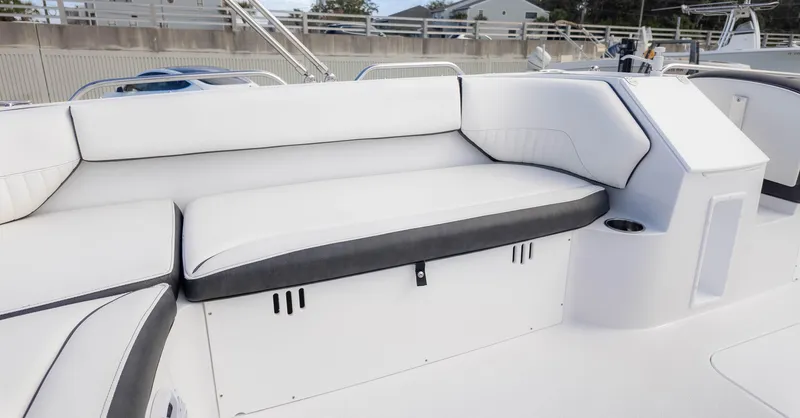 Slide: The Image of 2025 Stingray 192SC boat interior with white cushioned seating and storage compartment. - 15