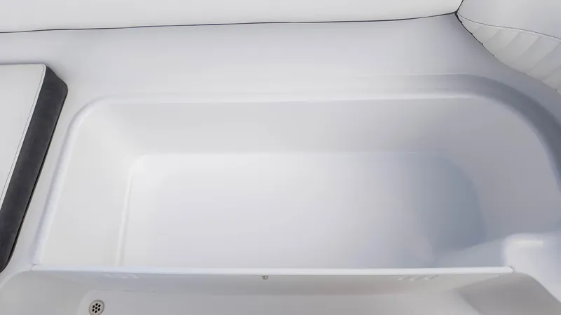 Slide: The Image of 2025 Stingray 192SC boat storage compartment, white interior, spacious design. - 16