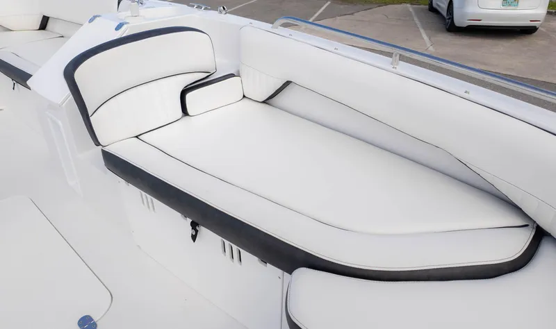 Slide: The Image of 2025 Stingray 192SC boat interior with white cushioned seating and black trim. - 19