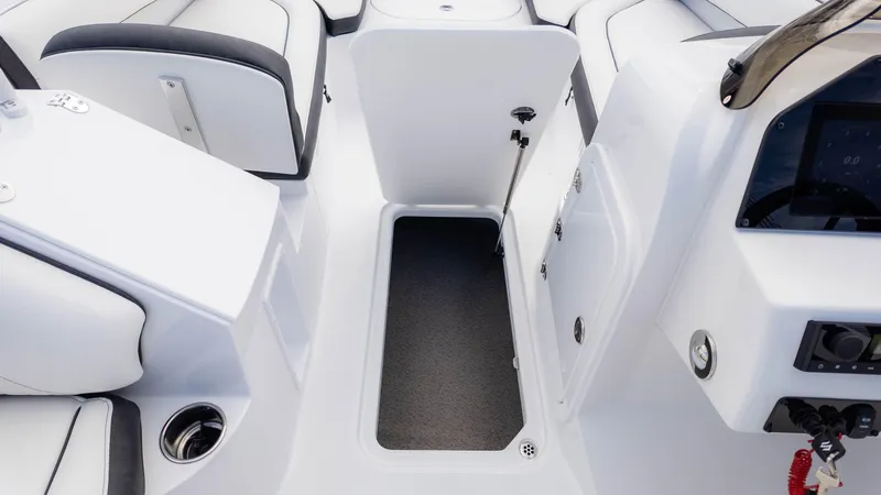 Slide: The Image of 2025 Stingray 192SC boat interior with open storage compartment and modern seating. - 24