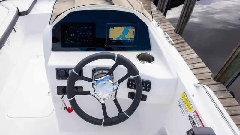 Slide: The Image of 2025 Stingray 192SC boat dashboard with steering wheel and navigation display. - 27