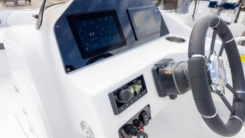 Slide: The Image of 2025 Stingray 192SC boat dashboard with modern controls and steering wheel. - 28