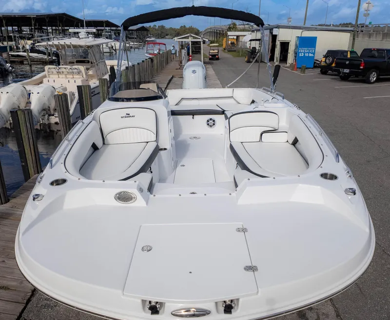 Slide: The Image of 2025 Stingray 192SC boat docked, featuring spacious seating and sleek design. - 3