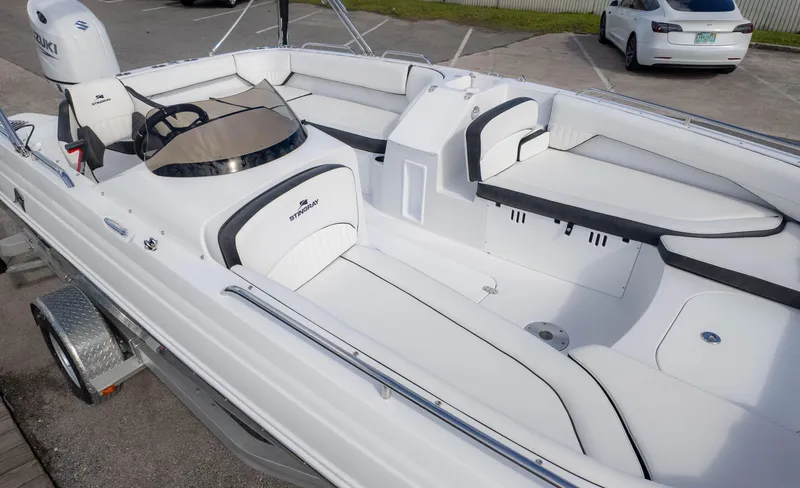 Slide: The Image of 2025 Stingray 192SC boat interior with white seating and steering console. - 4