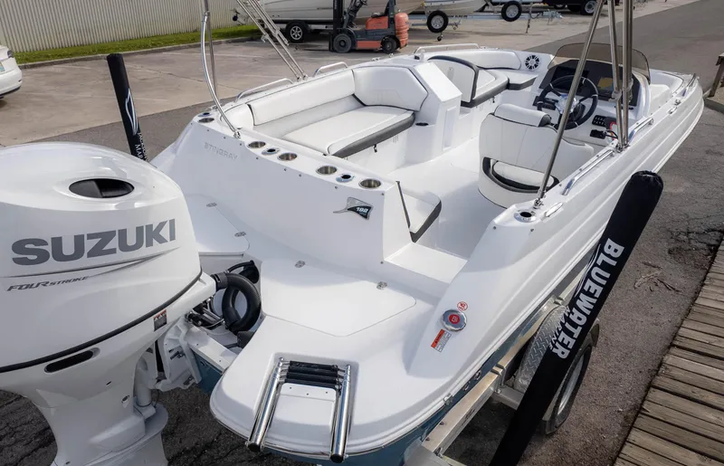 Slide: The Image of 2025 Stingray 192SC boat with Suzuki engine, docked, showcasing spacious seating and modern design. - 5