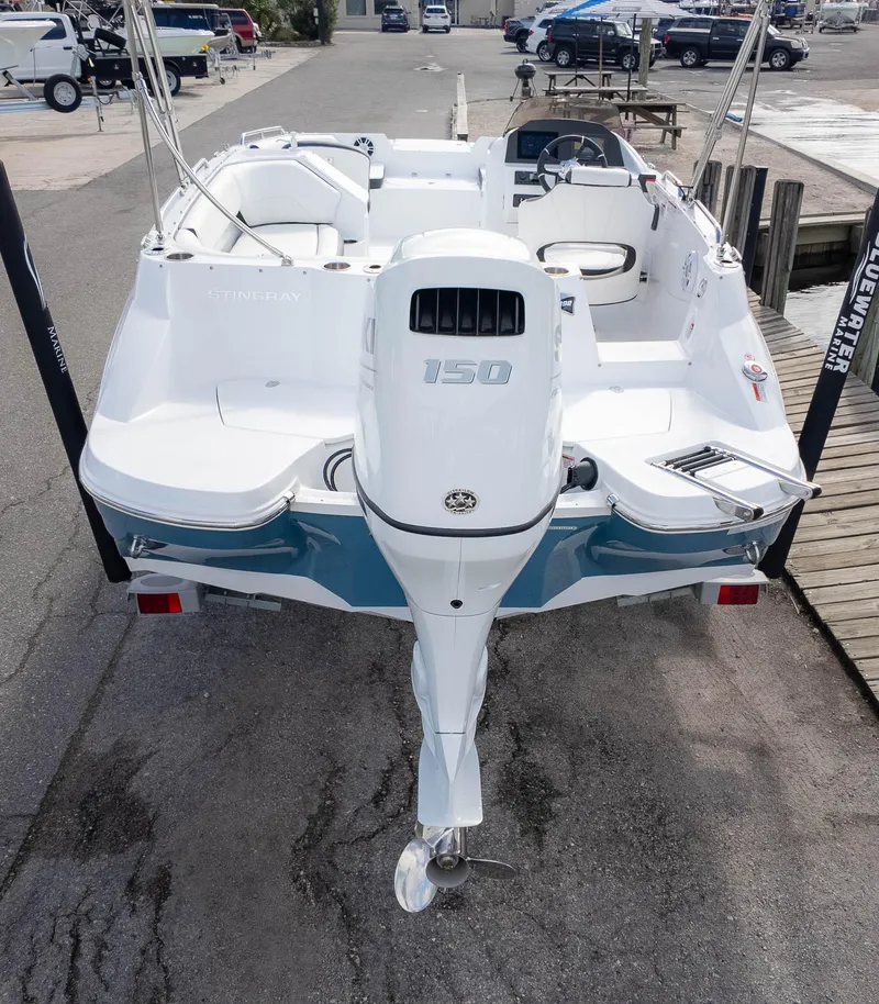 Slide: The Image of 2025 Stingray 192SC boat with 150 horsepower engine, docked at marina. - 6