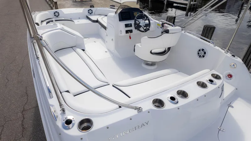 Slide: The Image of 2025 Stingray 192SC boat interior with white seating and modern dashboard. - 7