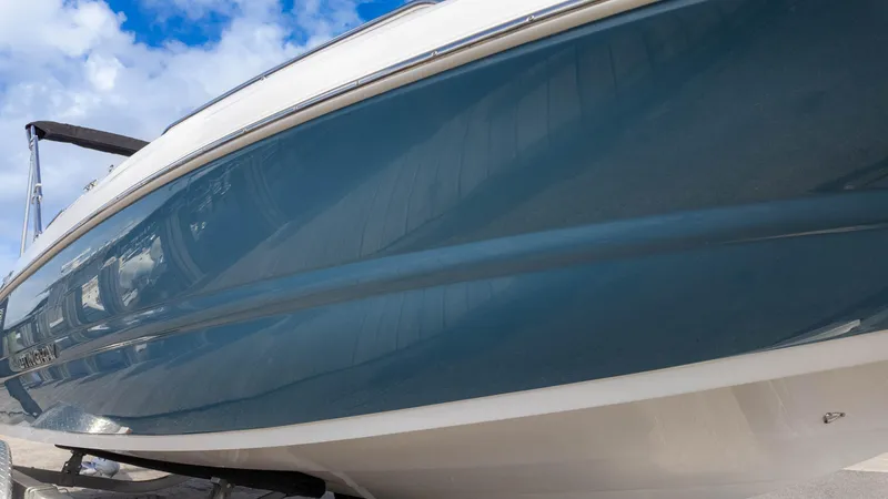 Slide: The Image of 2025 Stingray 192SC boat with sleek blue hull under a bright sky. - 8
