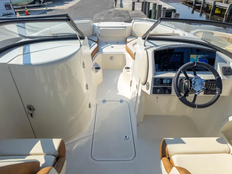 Slide: The Image of 2024 Stingray 211DC boat interior with modern dashboard and seating. - 10