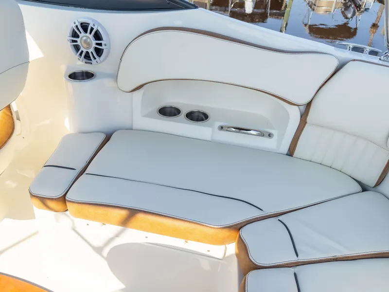 Slide: The Image of 2024 Stingray 211DC boat interior with white cushioned seating and cup holders. - 16