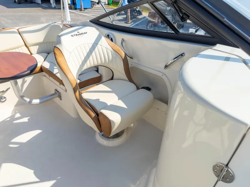 Slide: The Image of 2024 Stingray 211DC boat interior with luxurious seating and sleek design. - 20