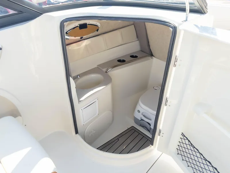 Slide: The Image of 2024 Stingray 211DC boat interior with compact bathroom and modern amenities. - 21