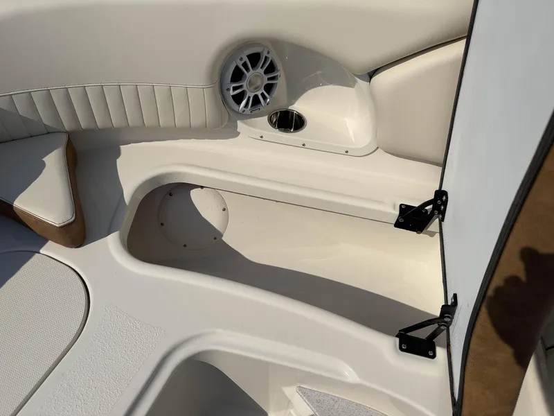 Slide: The Image of 2024 Stingray 211DC boat interior with speaker and storage compartment. - 26