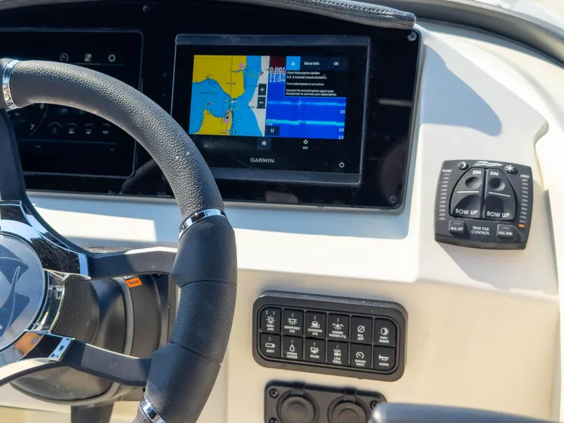 Slide: The Image of 2024 Stingray 211DC dashboard with Garmin navigation and control panel. - 32