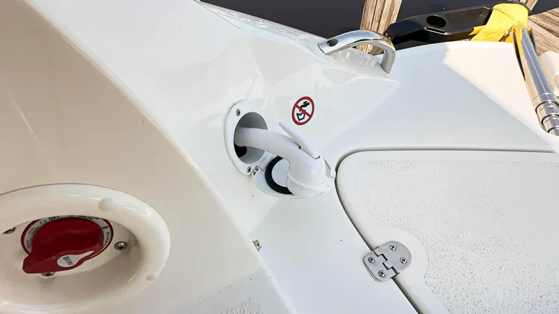 Slide: The Image of 2024 Stingray 211DC boat deck with fuel cap and hose connection. - 35