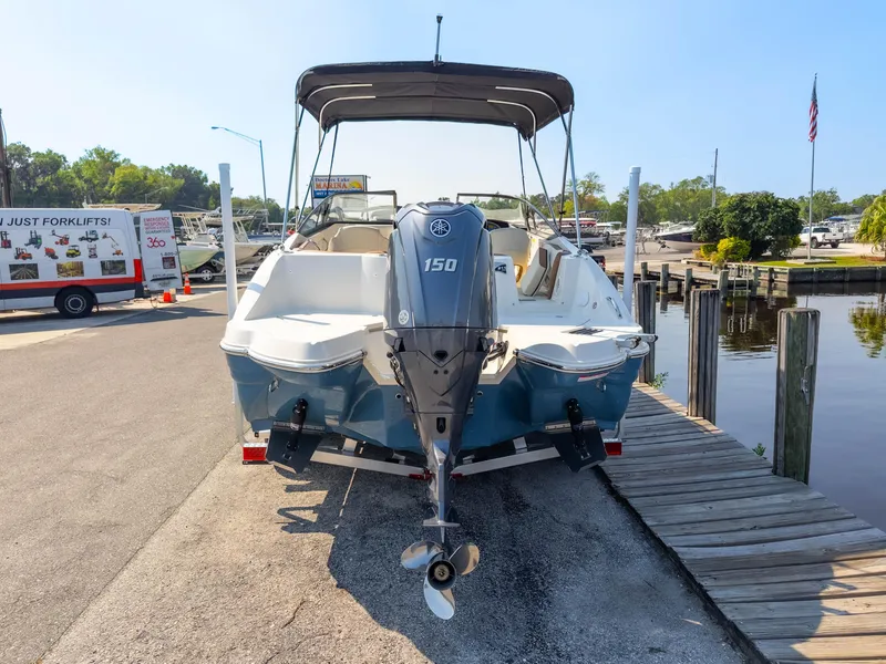 Slide: The Image of 2024 Stingray 211DC boat with Yamaha 150 engine docked at marina. - 37