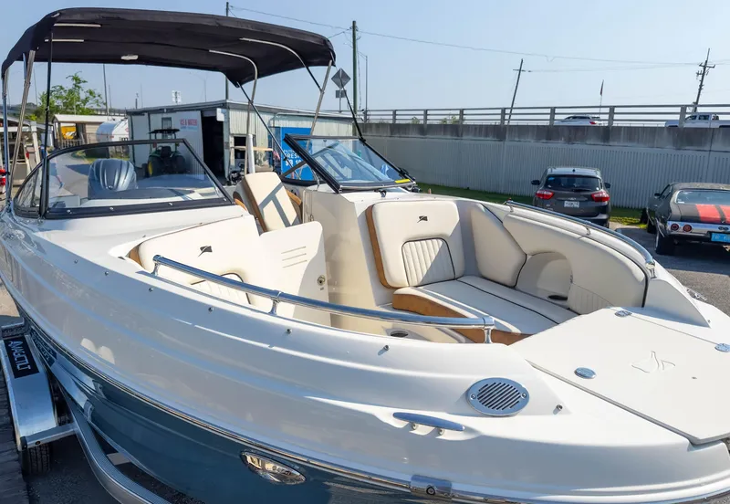 Slide: The Image of 2024 Stingray 211DC boat with spacious seating, sleek design, and modern features. - 6