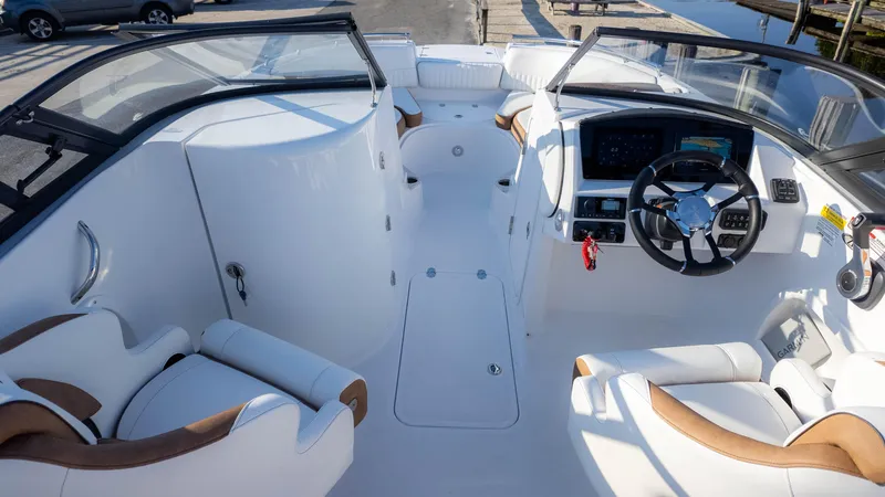 Slide: The Image of 2025 Stingray 231DC boat interior with modern dashboard and comfortable seating. - 11