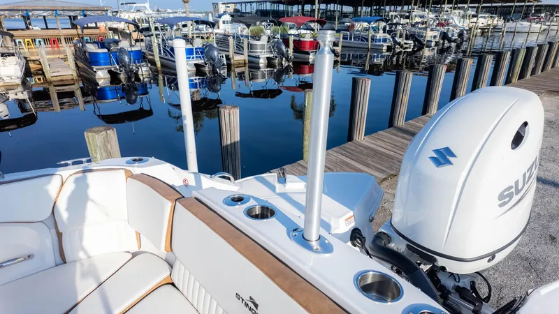 Slide: The Image of 2025 Stingray 231DC boat with Suzuki engine docked at marina. - 16