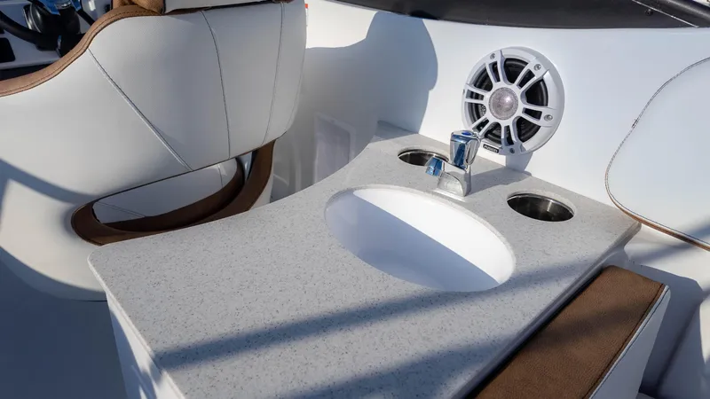 Slide: The Image of 2025 Stingray 231DC boat interior with sink, speaker, and seating. - 17