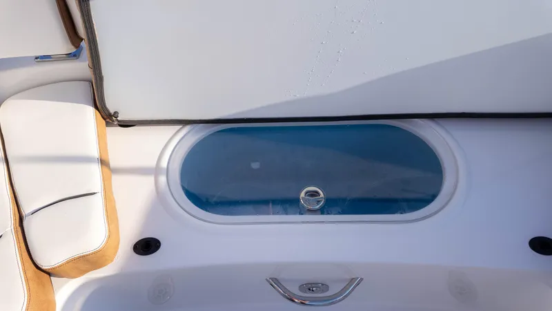 Slide: The Image of 2025 Stingray 231DC boat interior with seating and storage compartment. - 19