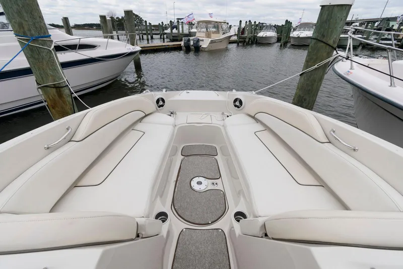 Slide: The Image of 2008 Sea Ray 260 Sundeck boat docked at marina, featuring spacious seating area. - 6
