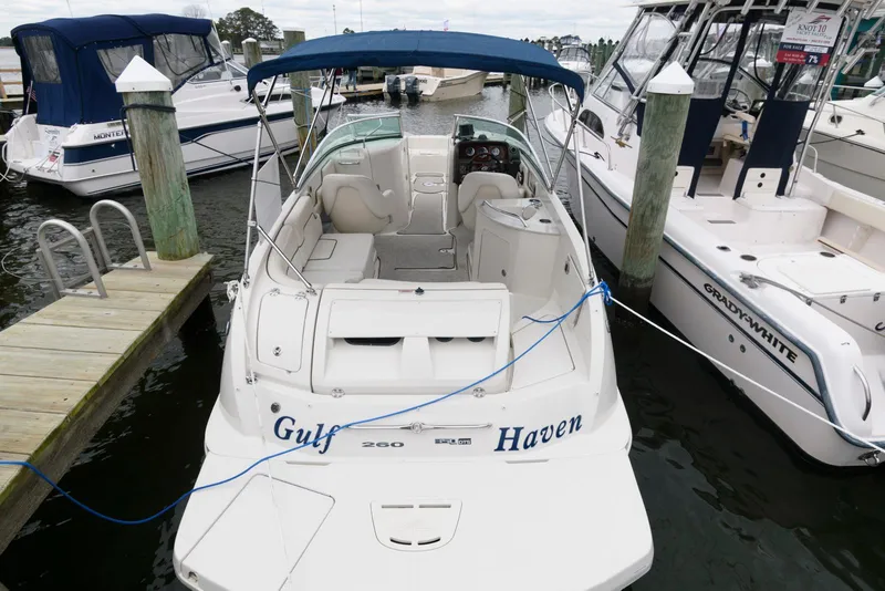 Slide: The Image of 2008 Sea Ray 260 Sundeck boat docked at marina with blue canopy. - 8