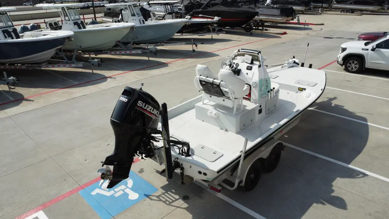 Slide: The Image of 2018 Shoalwater 21 CAT DLX boat with Suzuki engine on trailer in parking lot. - 11