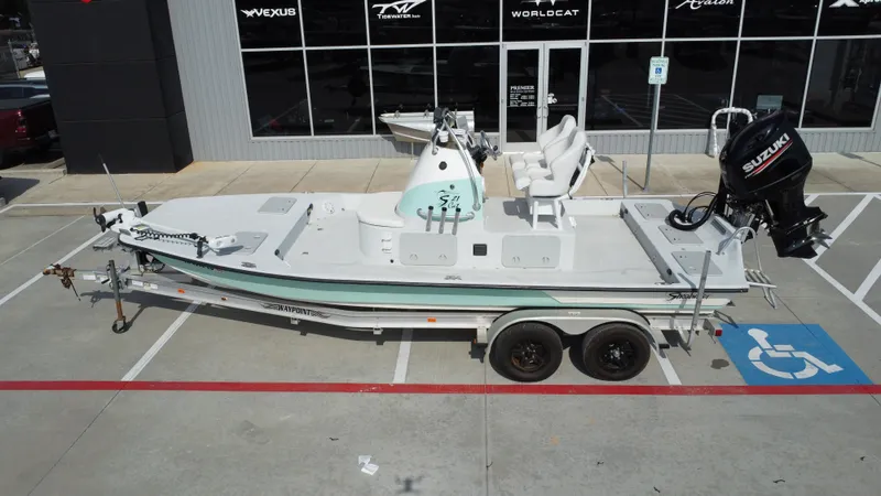 Slide: The Image of 2018 Shoalwater 21 CAT DLX boat on trailer, parked in front of dealership. - 16