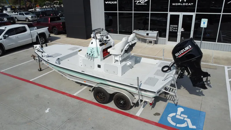 Slide: The Image of 2018 Shoalwater 21 CAT DLX boat with Suzuki outboard motor on trailer in parking lot. - 17