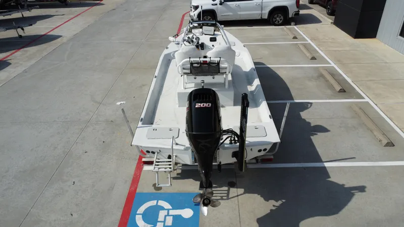 Slide: The Image of 2018 Shoalwater 21 CAT DLX boat with 200 HP engine in parking lot. - 18