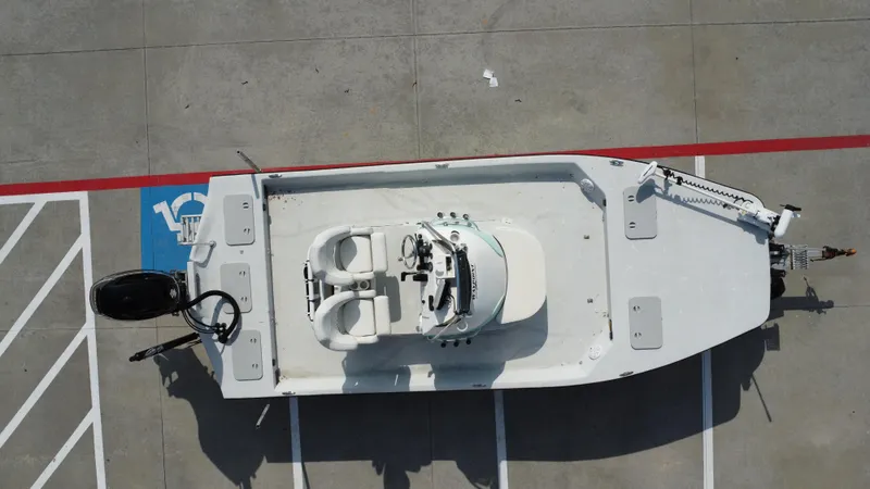 Slide: The Image of Overhead view of 2018 Shoalwater 21 CAT DLX boat parked on concrete. - 19