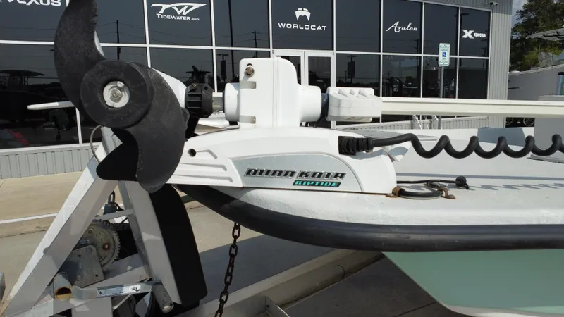 Slide: The Image of 2018 Shoalwater 21 CAT DLX with Minn Kota Riptide trolling motor, parked outside dealership. - 21