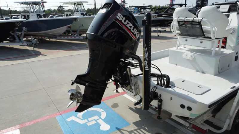 Slide: The Image of 2018 Shoalwater 21 CAT DLX boat with Suzuki outboard motor in a parking lot. - 26