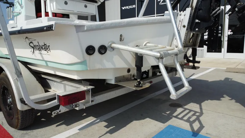 Slide: The Image of 2018 Shoalwater 21 CAT DLX boat rear view with trailer and ladder. - 28