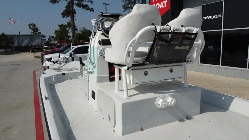 Slide: The Image of 2018 Shoalwater 21 CAT DLX boat with dual seats, parked outside a dealership. - 30