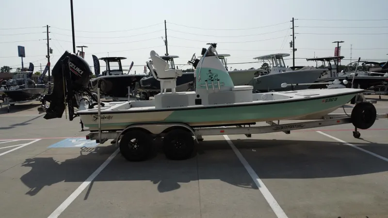 Slide: The Image of 2018 Shoalwater 21 CAT DLX boat on trailer in parking lot. - 6