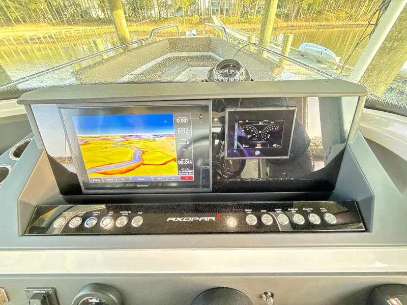 Slide: The Image of Dashboard of 2019 Axopar 28 CABIN with navigation and control screens. - 14