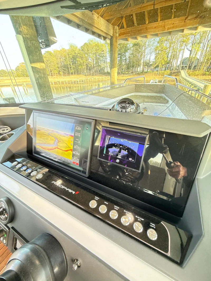 Slide: The Image of Control panel of 2019 Axopar 28 CABIN boat with navigation screens. - 23
