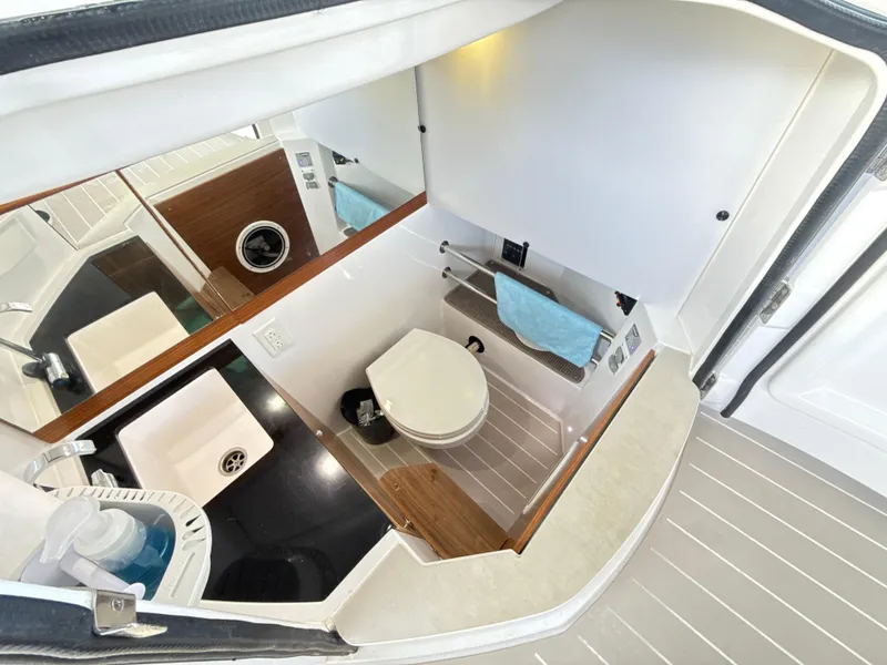 Slide: The Image of Interior of 2019 Axopar 28 CABIN boat bathroom with sink and toilet. - 32