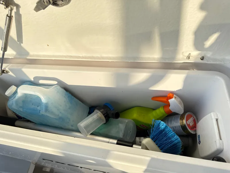 Slide: The Image of Storage compartment on a 2019 Axopar 28 CABIN with cleaning supplies and tools. - 39