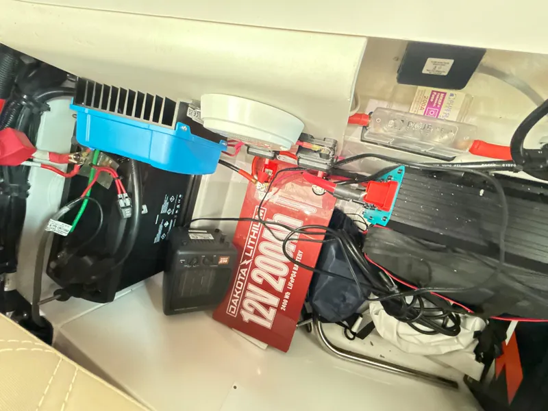 Slide: The Image of Electrical components inside a 2019 Axopar 28 CABIN boat, featuring a 12V battery system. - 41